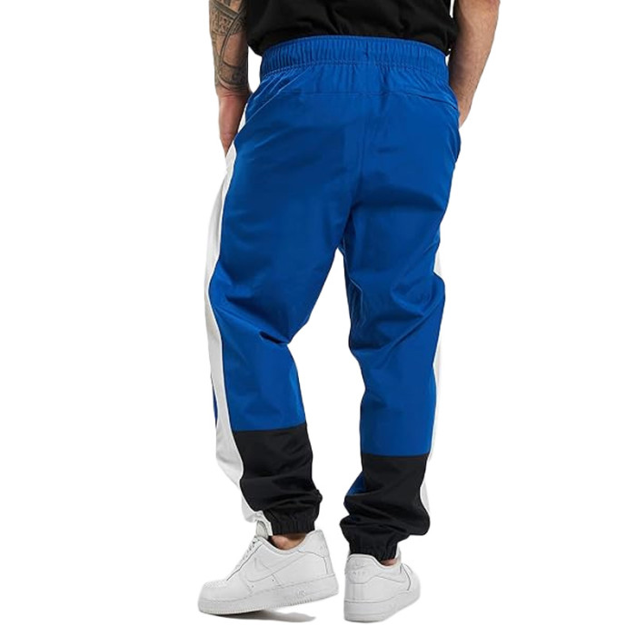 Pantalon de survêtement New Balance NB ATHLETICS WINDBREAKE