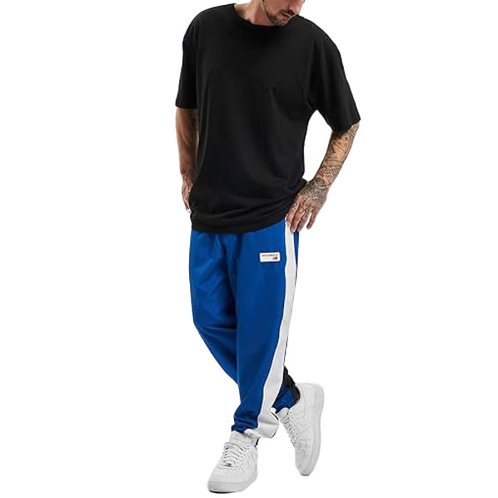 Pantalon de survêtement New Balance NB ATHLETICS WINDBREAKE